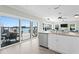 Bright kitchen featuring stainless steel appliances, a large island, and a sliding glass door to the deck at 2903 Pass A Grille Way, St Pete Beach, FL 33706