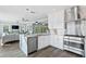 Modern kitchen with stainless steel appliances, marble countertops and waterfall backsplash at 2903 Pass A Grille Way, St Pete Beach, FL 33706