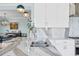 Bright kitchen with an island, stainless steel faucet, and white countertops at 2903 Pass A Grille Way, St Pete Beach, FL 33706