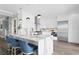 Modern kitchen boasts white cabinets, stainless steel appliances, and a marble island with seating at 2903 Pass A Grille Way, St Pete Beach, FL 33706