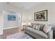 Cozy living room featuring a comfortable sofa, accent pillows, and tasteful artwork at 2903 Pass A Grille Way, St Pete Beach, FL 33706