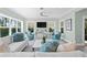 Cozy living room featuring a large sofa, two chairs, and views from the ample windows at 2903 Pass A Grille Way, St Pete Beach, FL 33706