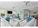 Bright and airy living room with comfortable seating, large windows and ceiling fans at 2903 Pass A Grille Way, St Pete Beach, FL 33706