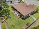 Aerial view of backyard with patio furniture set and a well manicured lawn and mature landscaping at 3041 Colonial Ridge Dr, Brandon, FL 33511