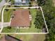Aerial view of home with large, fenced backyard, patio with seating, and well-maintained landscaping at 3041 Colonial Ridge Dr, Brandon, FL 33511