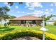 Spacious backyard featuring a well-maintained lawn, mature landscaping, and a cozy patio area at 3041 Colonial Ridge Dr, Brandon, FL 33511