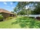 Picture perfect backyard featuring mature trees, green grass, and beautiful landscaping at 3041 Colonial Ridge Dr, Brandon, FL 33511