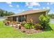 Beautifully landscaped backyard with a cozy patio area, lush plants, and inviting outdoor seating at 3041 Colonial Ridge Dr, Brandon, FL 33511