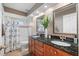 Bathroom featuring a double vanity with granite countertops and a shower with a tub at 3041 Colonial Ridge Dr, Brandon, FL 33511