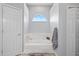 Elegant bathroom with a soaking tub, tiled surround, and a window for natural light at 3041 Colonial Ridge Dr, Brandon, FL 33511