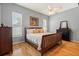 Comfortable bedroom featuring hardwood floors, ceiling fan, and serene natural light through the windows at 3041 Colonial Ridge Dr, Brandon, FL 33511