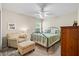 Cozy bedroom with neutral tones, ceiling fan, and comfortable seating area at 3041 Colonial Ridge Dr, Brandon, FL 33511