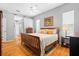Inviting bedroom with hardwood floors, neutral tones, and plenty of natural light creating a cozy retreat at 3041 Colonial Ridge Dr, Brandon, FL 33511