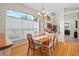 Dining room with hardwood floors, natural light, and stylish chandelier at 3041 Colonial Ridge Dr, Brandon, FL 33511