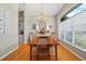 Dining room features hardwood floors, a large window, and a dining table perfect for gatherings and entertaining at 3041 Colonial Ridge Dr, Brandon, FL 33511
