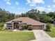 Spacious single-story house showcasing well-kept grounds and a long driveway leading to the attached garage at 3041 Colonial Ridge Dr, Brandon, FL 33511