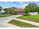Single-story house showcasing well-kept grounds and a long driveway leading to the attached garage at 3041 Colonial Ridge Dr, Brandon, FL 33511