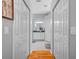 Hallway view leading to the bright bathroom with dual vanities, enhancing privacy and convenience at 3041 Colonial Ridge Dr, Brandon, FL 33511