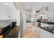 Spacious kitchen featuring granite countertops, stainless steel appliances, and white cabinetry at 3041 Colonial Ridge Dr, Brandon, FL 33511