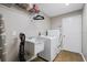 Functional laundry room with utility sink, washer, and dryer, offering convenience and efficiency at 3041 Colonial Ridge Dr, Brandon, FL 33511