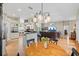 Bright, open-concept living room with tile flooring and a dining space with modern lighting at 3041 Colonial Ridge Dr, Brandon, FL 33511