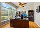 Bright home office boasts built-in bookcases, a large window, and plenty of workspace with a large executive desk at 3041 Colonial Ridge Dr, Brandon, FL 33511