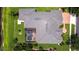 Aerial view of expansive roof, screened pool, and well-manicured landscaping in a verdant neighborhood at 3123 Whitehead Ln, Land O Lakes, FL 34638