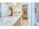 Bright bathroom featuring double sinks, marble countertops, and entry to the bedroom at 3123 Whitehead Ln, Land O Lakes, FL 34638