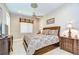 Comfortable bedroom with a ceiling fan, decorative ceiling medallion, and luxurious bedding at 3123 Whitehead Ln, Land O Lakes, FL 34638