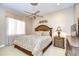 Bright bedroom featuring a ceiling fan, elegant window treatments, and a warm color palette at 3123 Whitehead Ln, Land O Lakes, FL 34638