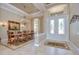 Elegant dining room with crystal chandelier, ornate mirror, and decorative rug at 3123 Whitehead Ln, Land O Lakes, FL 34638