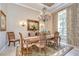 A dining room showcases a chandelier, floral curtains, and a decorative mirror at 3123 Whitehead Ln, Land O Lakes, FL 34638