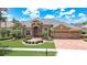 Charming home with manicured lawn, mature palms and brick paver driveway and entry in a gated community at 3123 Whitehead Ln, Land O Lakes, FL 34638