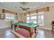 Spacious game room with a pool table and large windows offering beautiful waterfront views at 3123 Whitehead Ln, Land O Lakes, FL 34638