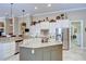 A kitchen with a center island, granite countertops, and stainless steel appliances at 3123 Whitehead Ln, Land O Lakes, FL 34638