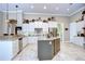 A modern kitchen with white cabinetry, granite countertops, and a center island at 3123 Whitehead Ln, Land O Lakes, FL 34638