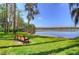 Scenic view of the lake from a shady bench under Spanish Moss trees at 3123 Whitehead Ln, Land O Lakes, FL 34638