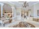 An elegant living room features architectural columns, a chandelier, and neutral decor at 3123 Whitehead Ln, Land O Lakes, FL 34638