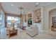 Spacious living room features tray ceilings, recessed lighting, and pool views at 3123 Whitehead Ln, Land O Lakes, FL 34638