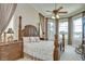 Tranquil main bedroom featuring bay windows, tray ceiling, and neutral decor at 3123 Whitehead Ln, Land O Lakes, FL 34638