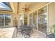 Outdoor patio with a ceiling fan, dining table, and large sliding glass doors at 3123 Whitehead Ln, Land O Lakes, FL 34638