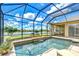 Stunning screened pool area overlooking the water, with lovely landscaping and outdoor seating at 3123 Whitehead Ln, Land O Lakes, FL 34638