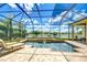 Gorgeous screened pool area with waterfront views and inviting lounge seating at 3123 Whitehead Ln, Land O Lakes, FL 34638