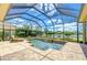 Beautiful screened pool with a water view and brick patio at 3123 Whitehead Ln, Land O Lakes, FL 34638