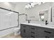 Modern bathroom featuring stylish vanity, large mirror and glass enclosed shower at 33487 Azalea Ridge Dr, Wesley Chapel, FL 33545