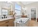 Elegant bathroom boasts marble countertops, large soaking tub and a bright airy atmosphere at 33487 Azalea Ridge Dr, Wesley Chapel, FL 33545