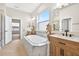 Bright bathroom with soaking tub, and sinks and views into the glass walk-in shower at 33487 Azalea Ridge Dr, Wesley Chapel, FL 33545