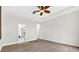 Bright bedroom boasting wood floors, ceiling fan and doorway to a luxury bath and walk-in closet at 33487 Azalea Ridge Dr, Wesley Chapel, FL 33545