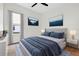 Light and airy bedroom featuring blue accents, two landscape pictures, and a window with blinds at 33487 Azalea Ridge Dr, Wesley Chapel, FL 33545