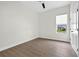 Bright bedroom featuring light wood floor and window with a view of landscaping at 33487 Azalea Ridge Dr, Wesley Chapel, FL 33545